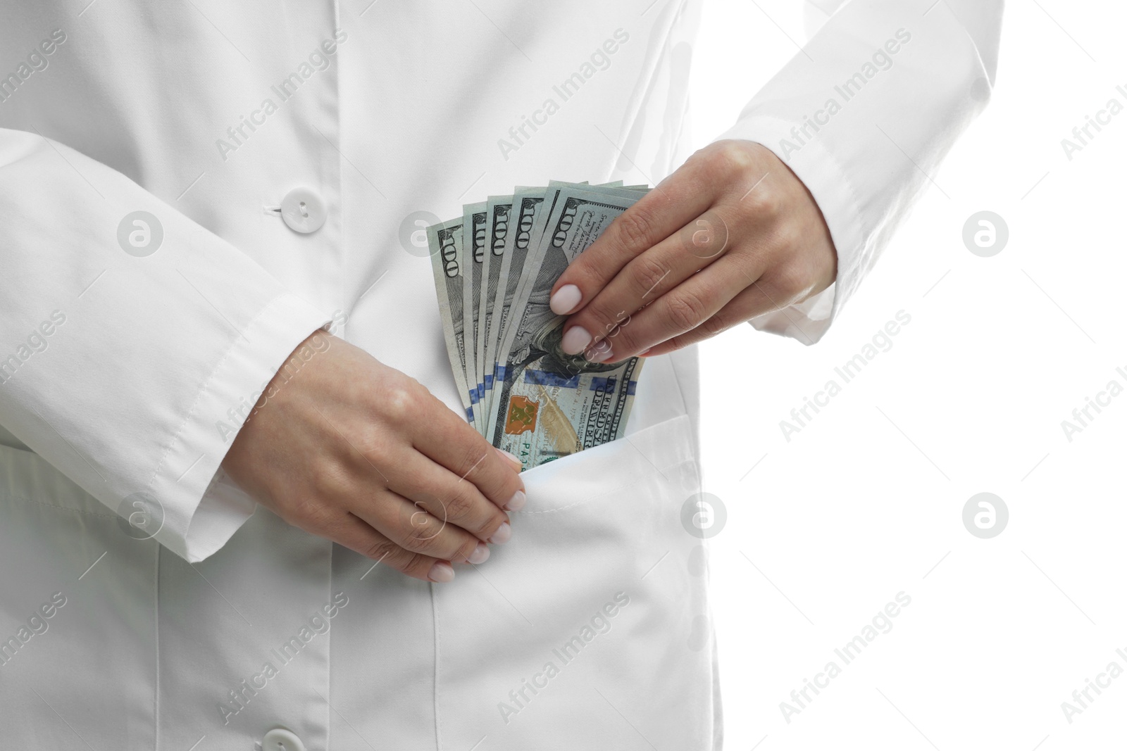 Photo of Corruption concept. Doctor putting dollar banknotes into her pocket on white background, closeup