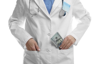 Photo of Corruption concept. Doctor putting dollar banknotes into her pocket on white background, closeup