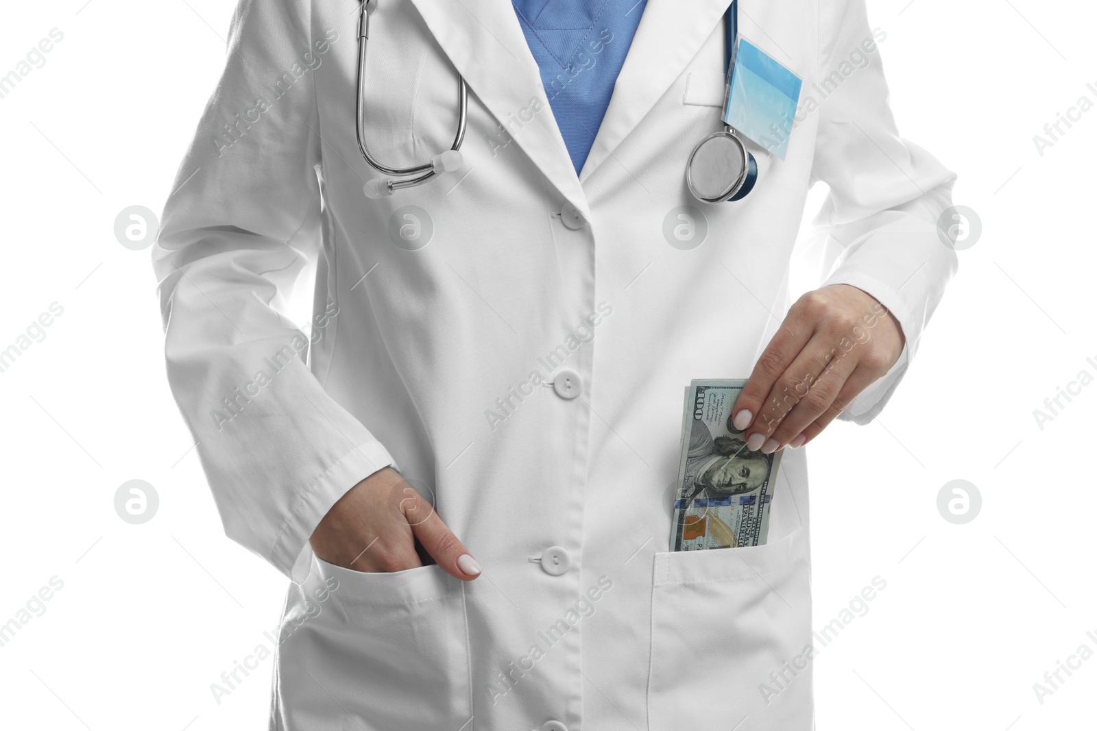 Photo of Corruption concept. Doctor putting dollar banknotes into her pocket on white background, closeup