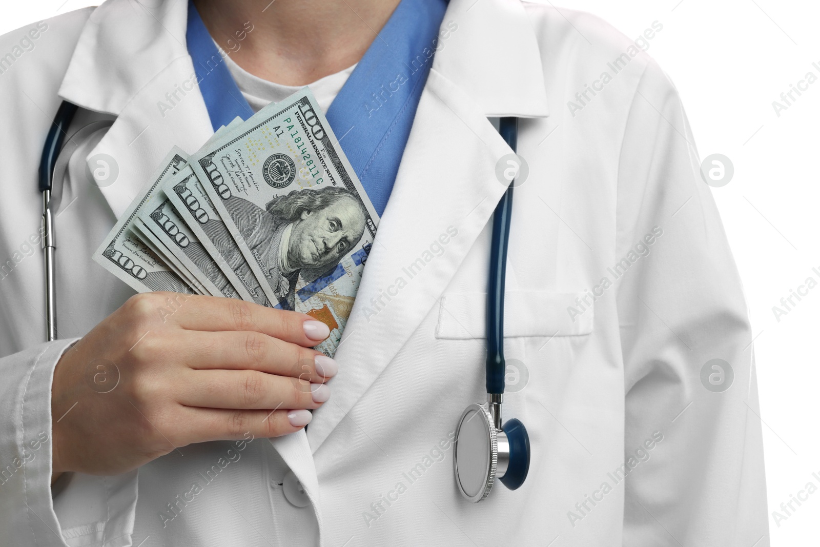 Photo of Corruption concept. Doctor putting dollar banknotes into her coat on white background, closeup