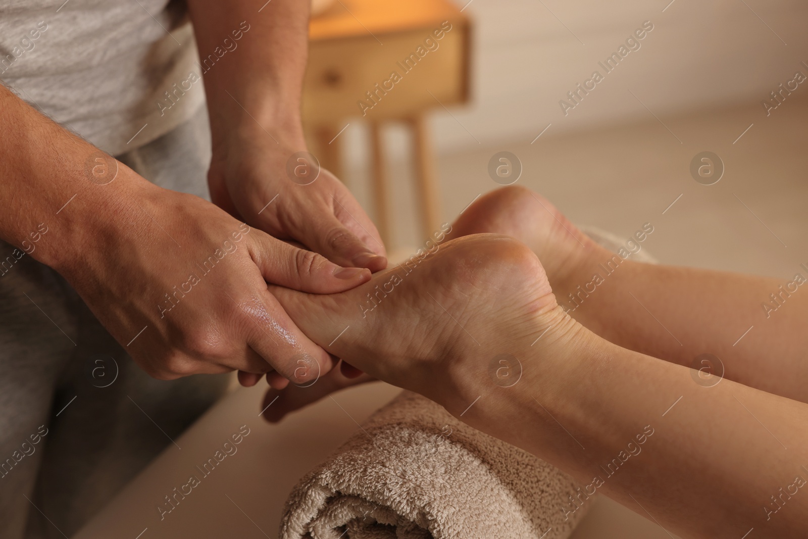 Photo of Osteopath working with patient indoors, closeup. Manual therapy