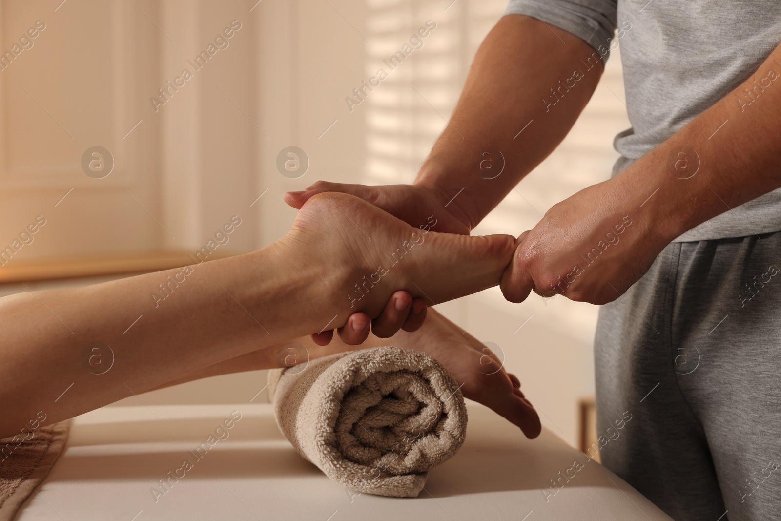 Photo of Osteopath working with patient indoors, closeup. Manual therapy