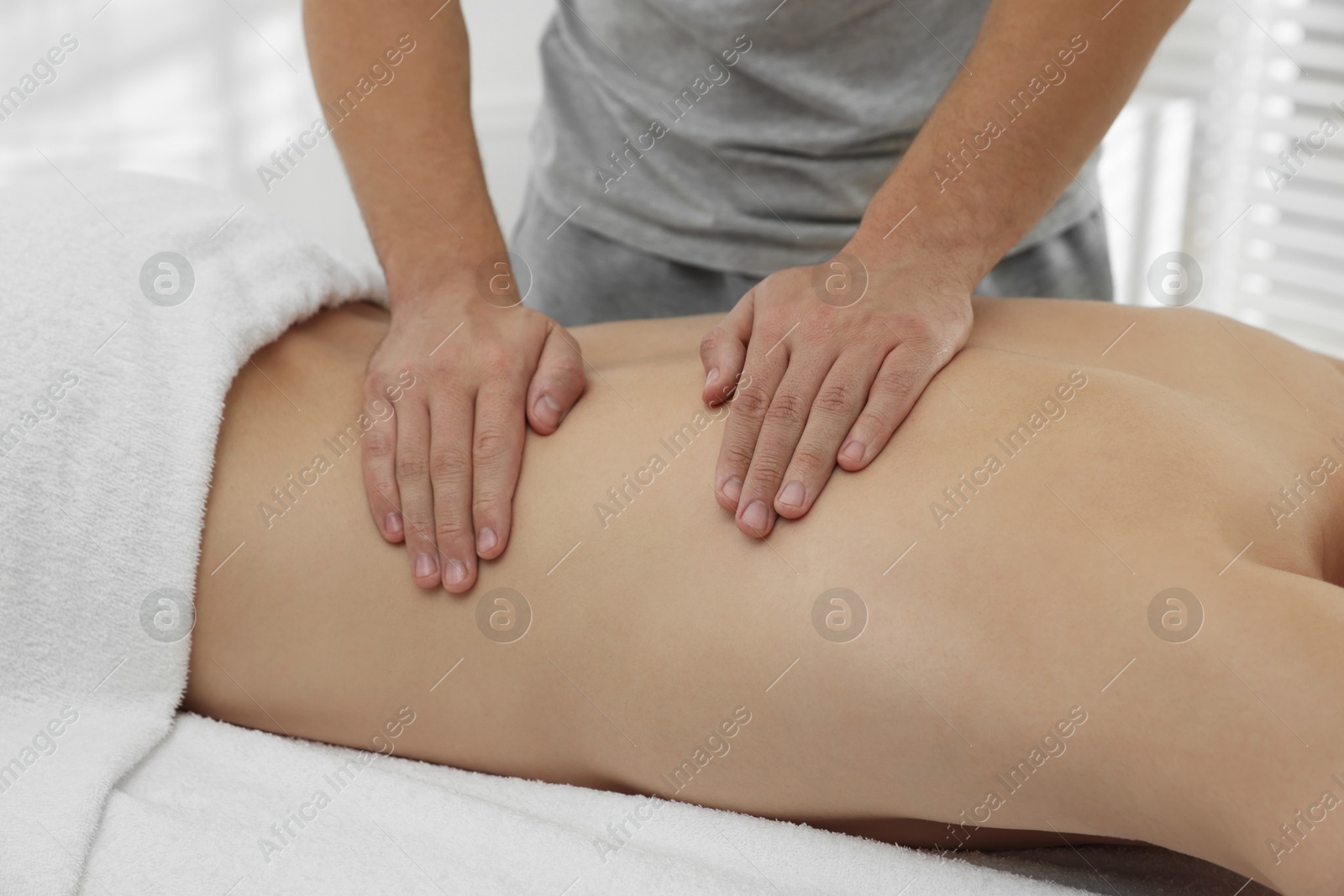 Photo of Massage therapist working with patient in clinic, closeup