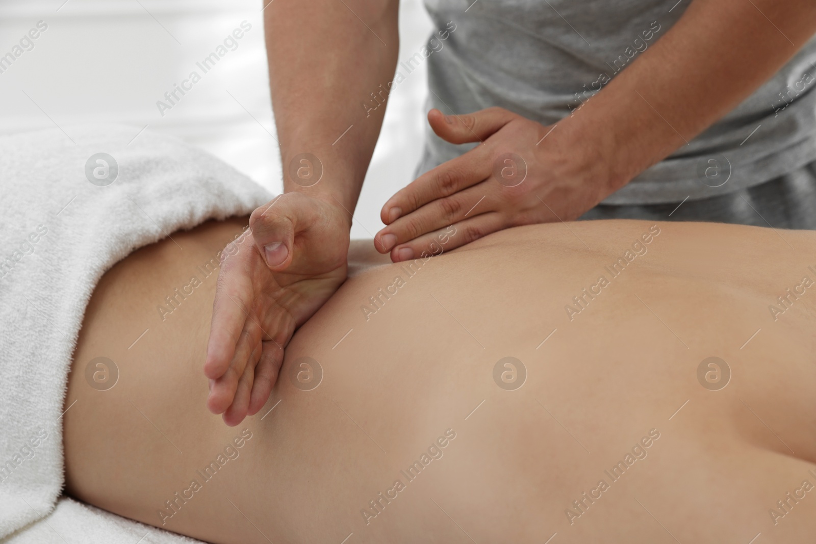 Photo of Massage therapist working with patient in clinic, closeup