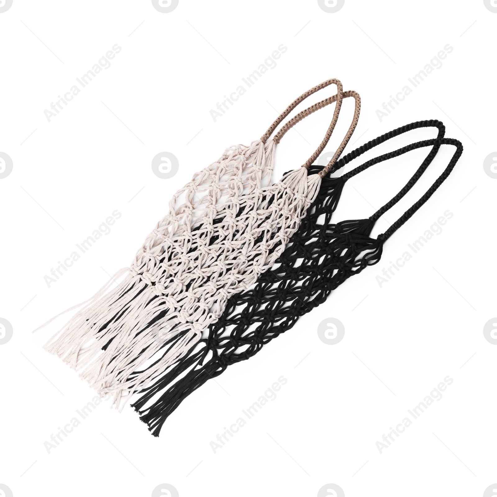 Photo of Two macrame shopping bags isolated on white, top view