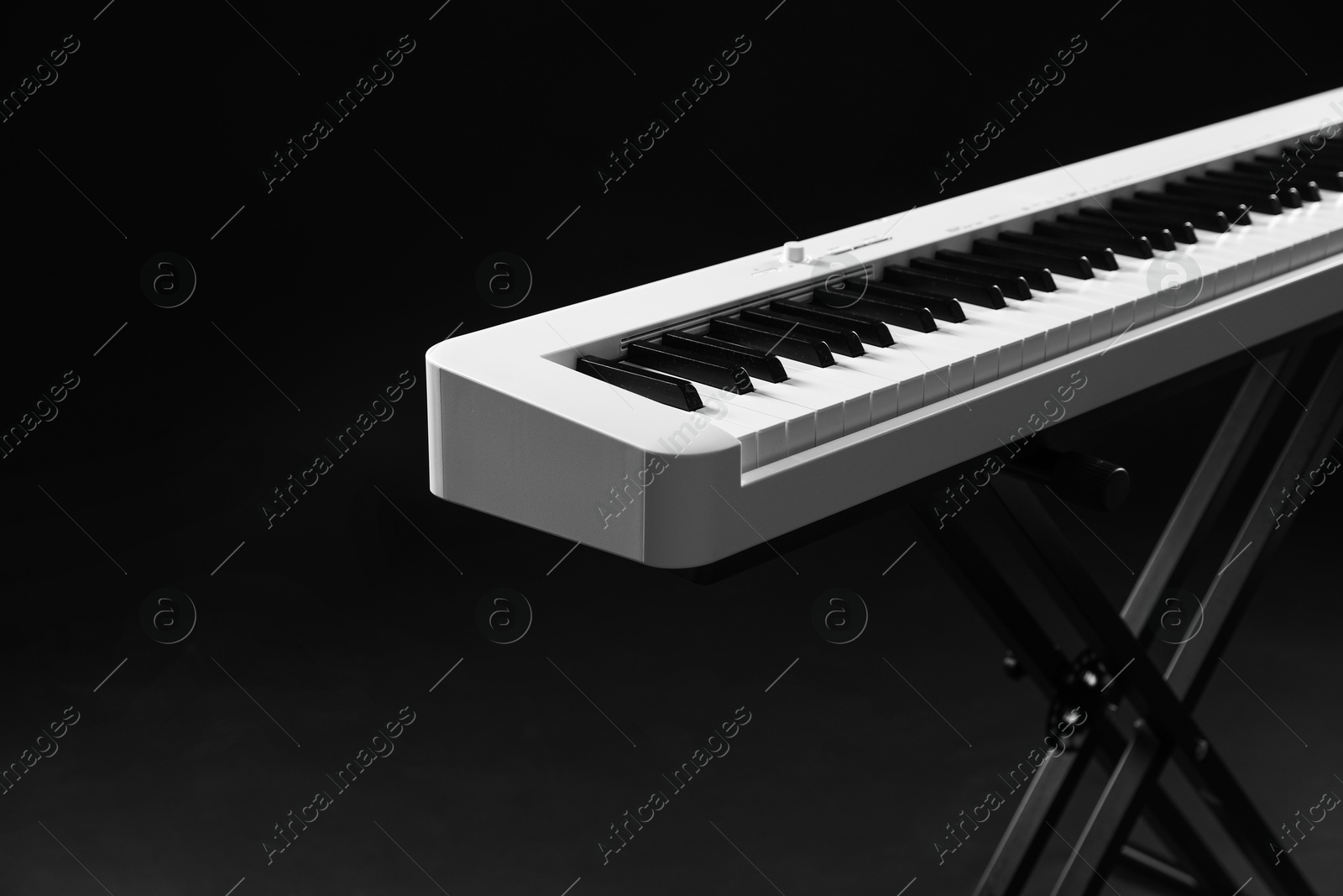 Photo of Synthesizer on black background, closeup. Electronic musical instrument