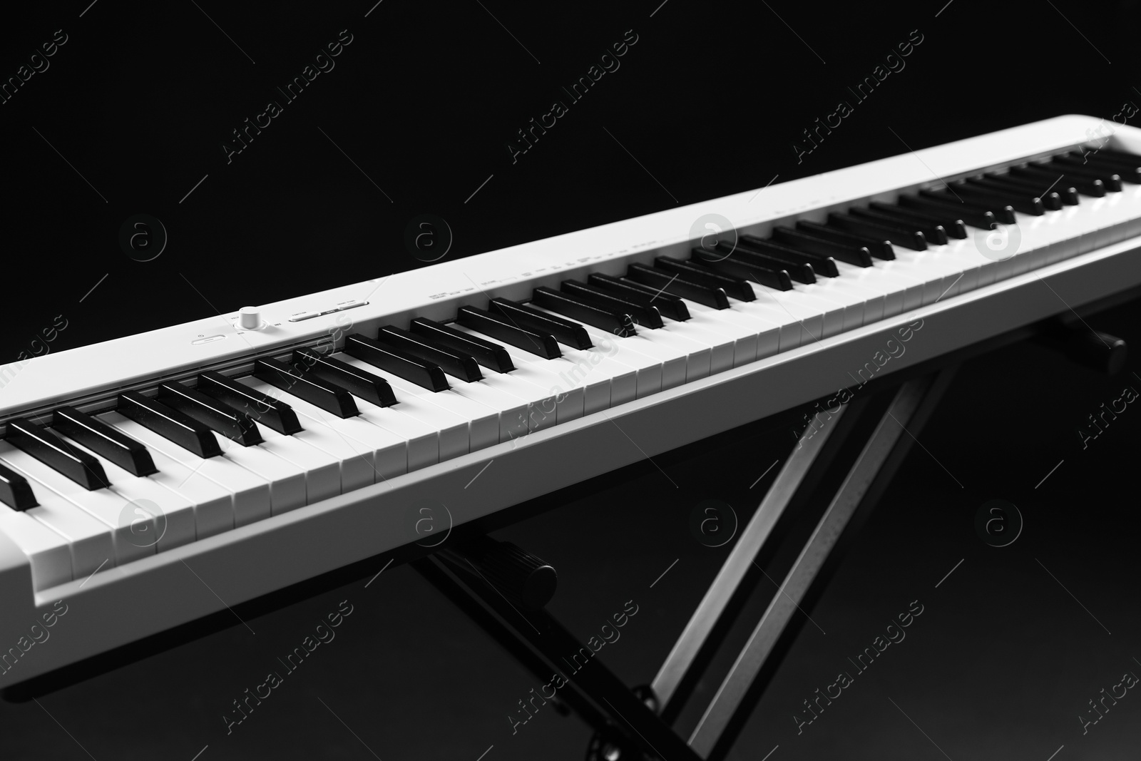 Photo of Synthesizer on black background, closeup. Electronic musical instrument