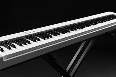 Photo of Synthesizer on black background, closeup. Electronic musical instrument