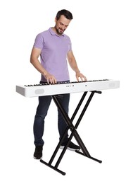 Photo of Bearded man playing synthesizer on white background