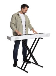 Photo of Smiling man playing synthesizer on white background