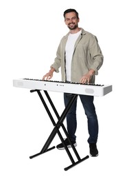 Photo of Smiling man playing synthesizer on white background