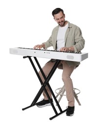 Photo of Smiling man playing synthesizer on white background