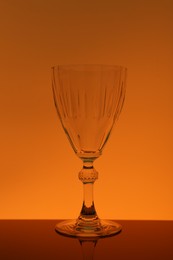 Photo of One empty glass on table, color tone effect