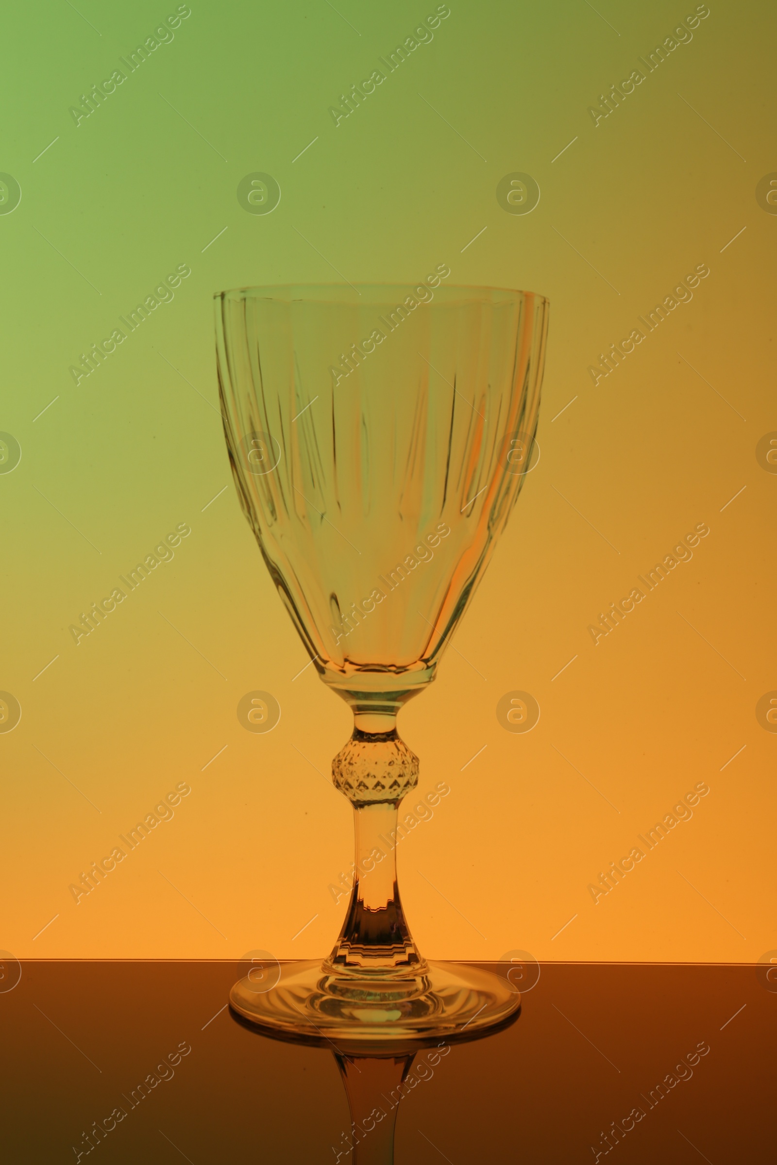 Photo of One empty glass on table, color tone effect