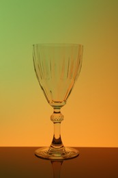 Photo of One empty glass on table, color tone effect