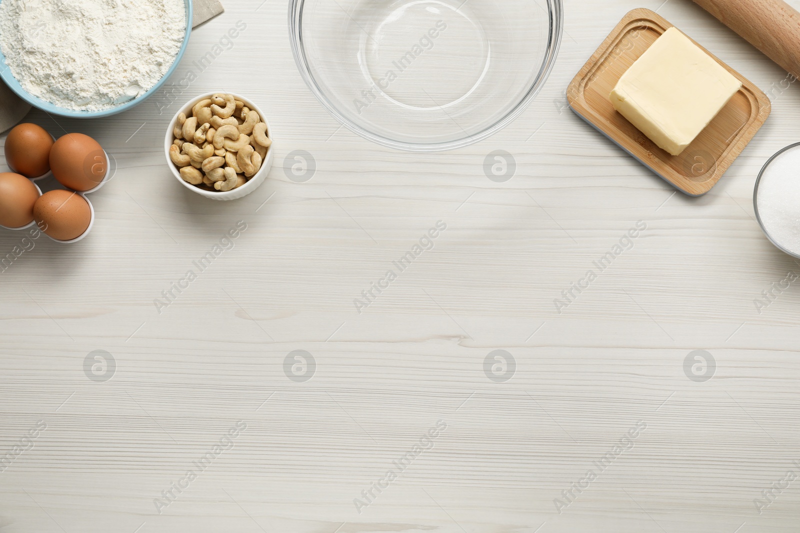 Photo of Different ingredients for cookies on white wooden table, flat lay. Space for text