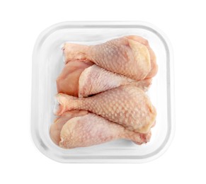 Photo of Frozen chicken drumsticks in container isolated on white, top view