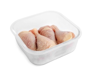 Photo of Frozen chicken drumsticks in container isolated on white