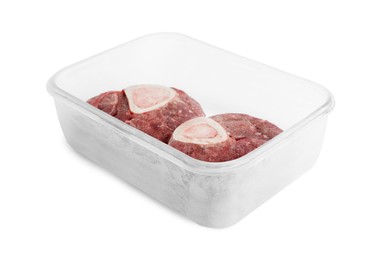 Photo of Frozen beef steaks in container isolated on white