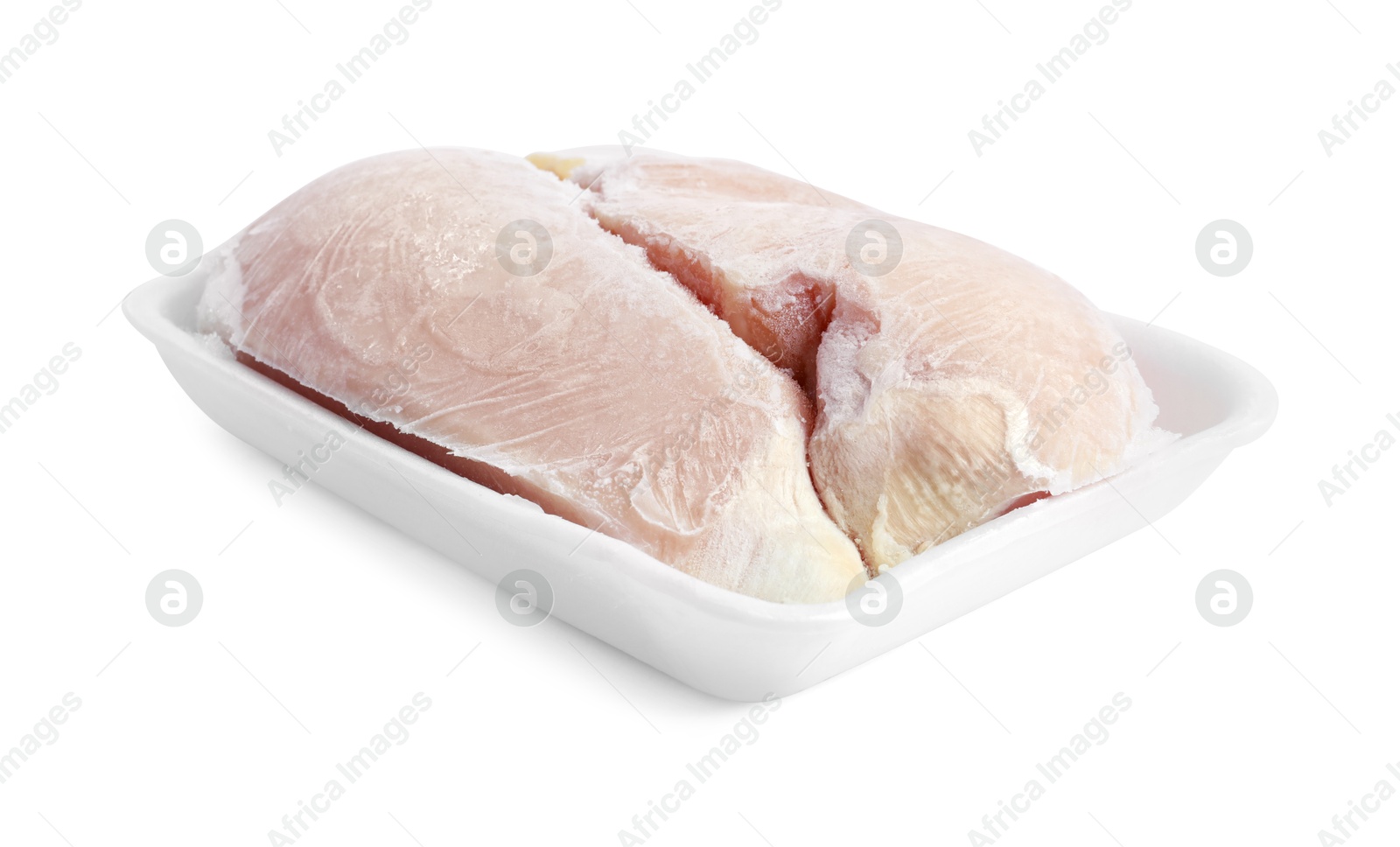 Photo of Frozen chicken breasts in container isolated on white