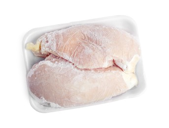 Photo of Frozen chicken breasts in container isolated on white, top view