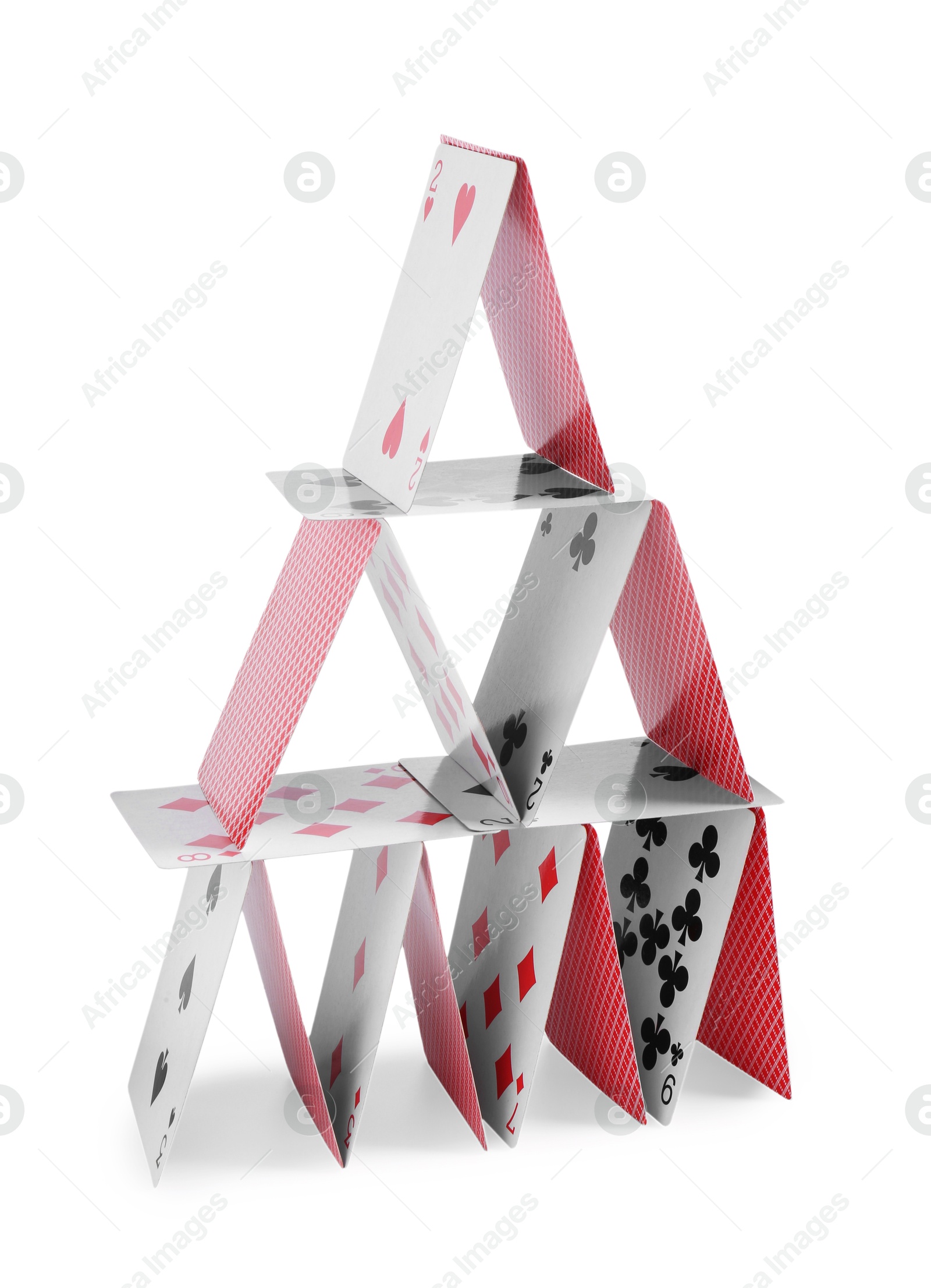 Photo of House of playing cards isolated on white