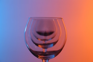 Photo of Wine glasses on color background, closeup view