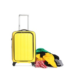 Photo of Suitcase and messy pile of clothes isolated on white