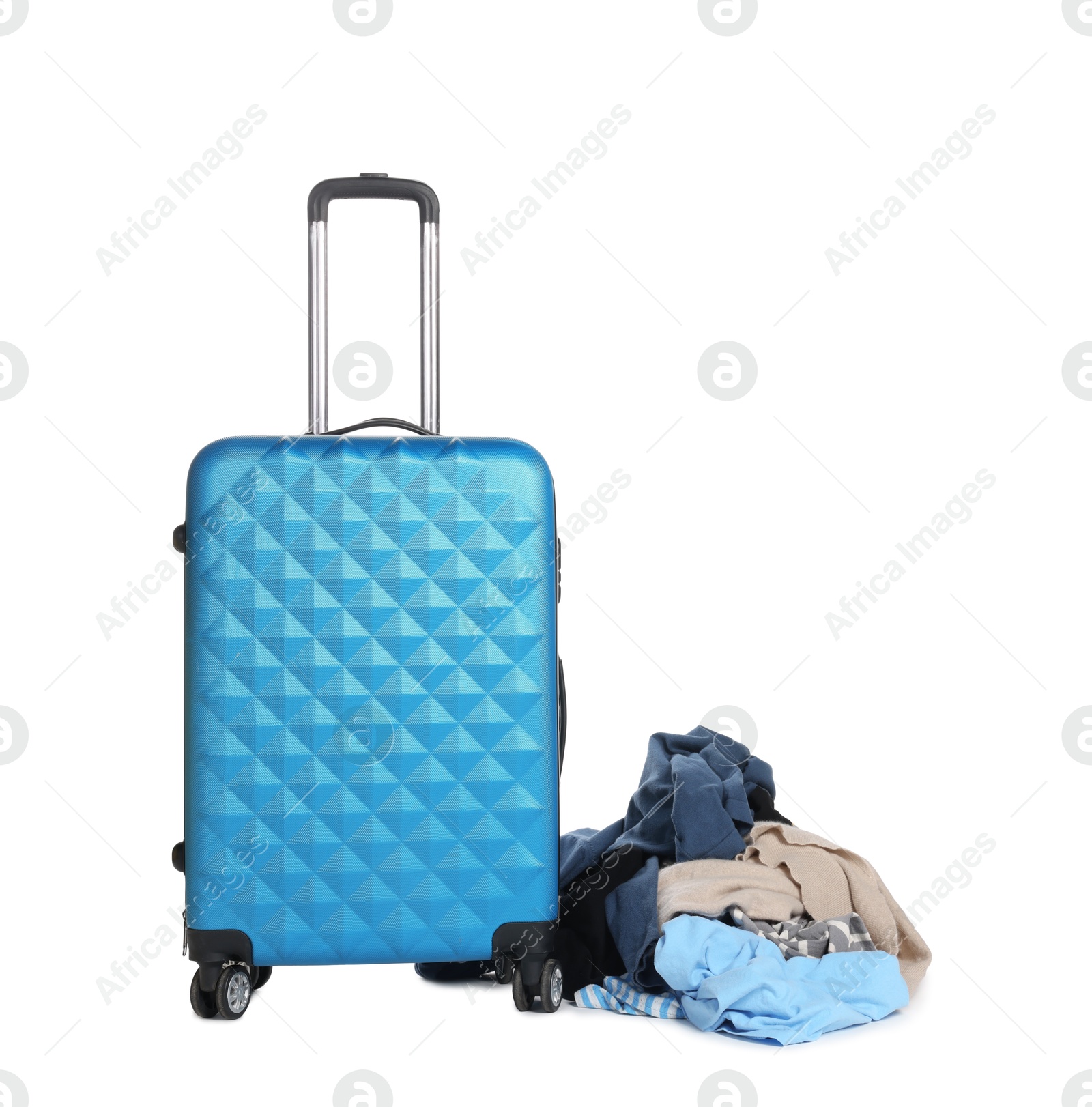 Photo of Suitcase and messy pile of clothes isolated on white