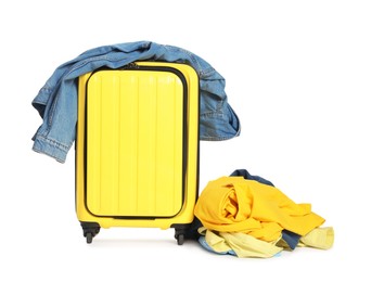 Photo of Suitcase and messy pile of clothes isolated on white