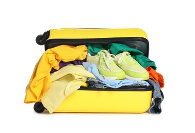 Photo of Packed suitcase full of clothes isolated on white