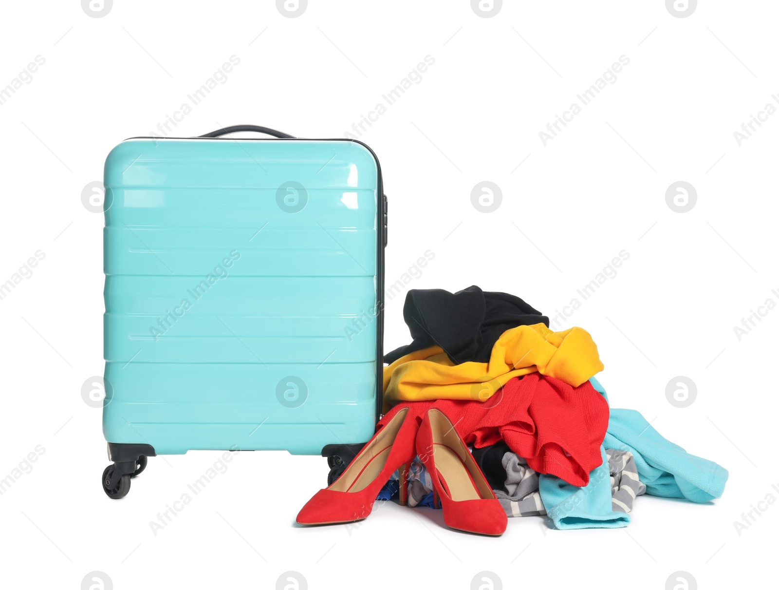 Photo of Suitcase and messy pile of clothes isolated on white