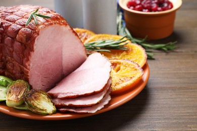 Christmas food. Tasty baked ham served on wooden table, closeup