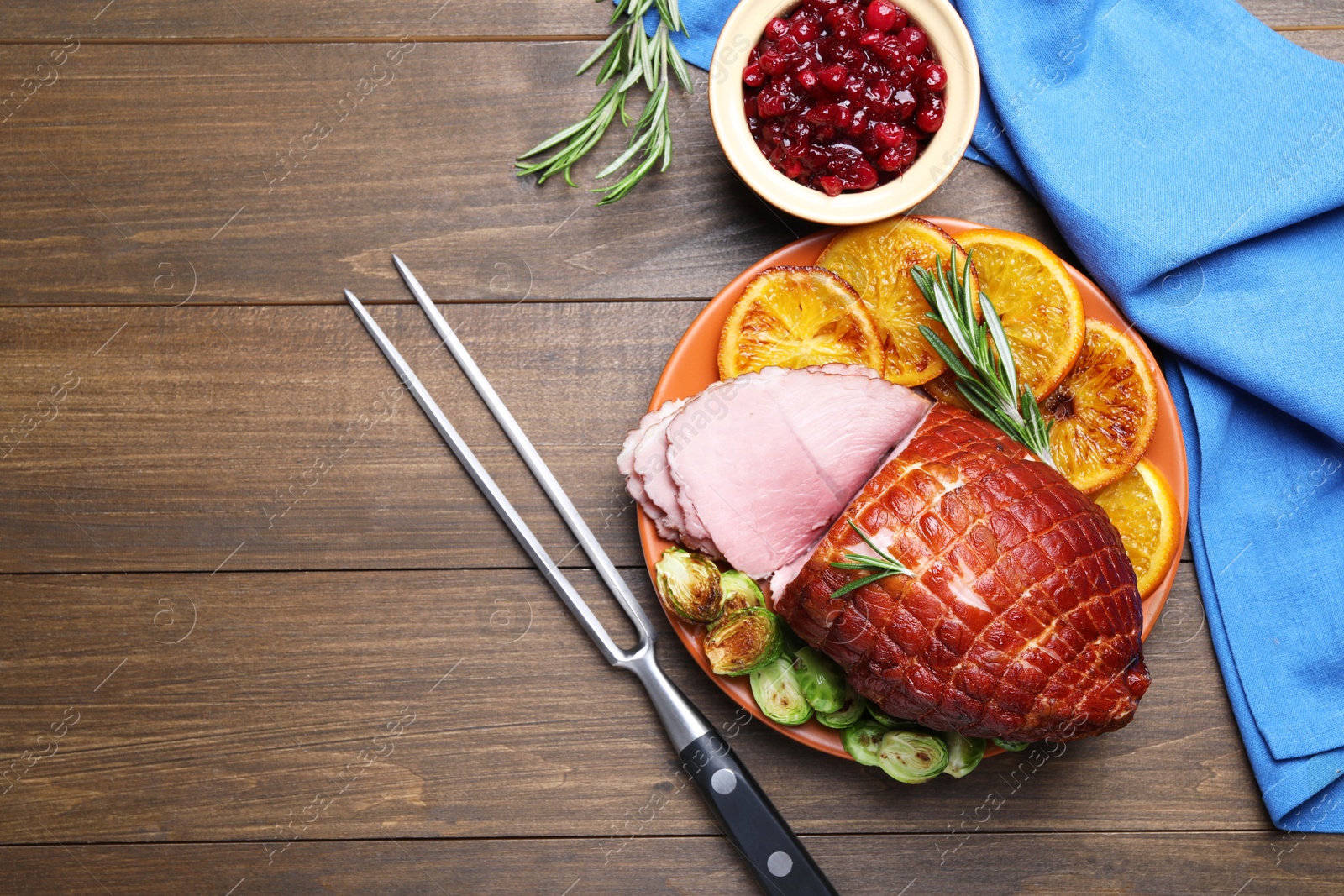 Photo of Christmas food. Tasty baked ham served on wooden table, flat lay and space for text