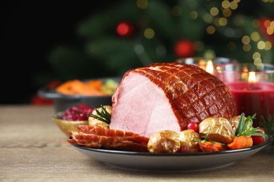 Photo of Christmas food. Tasty baked ham served on wooden table, closeup