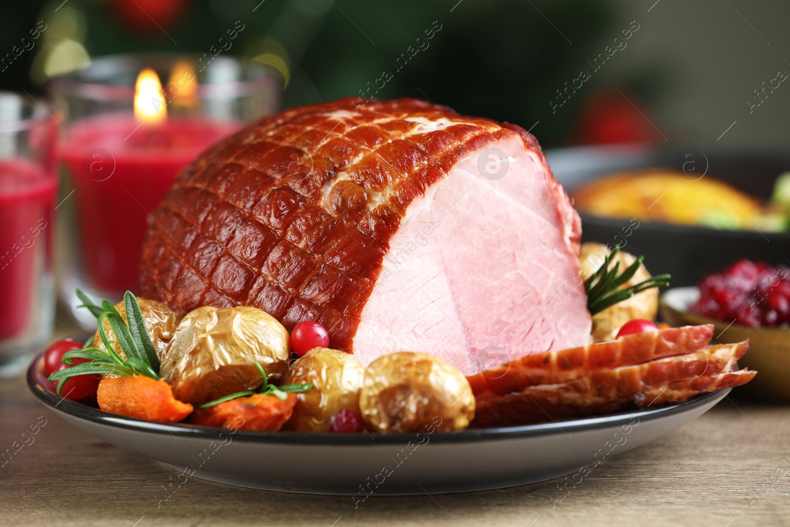 Photo of Christmas food. Tasty baked ham served on wooden table, closeup