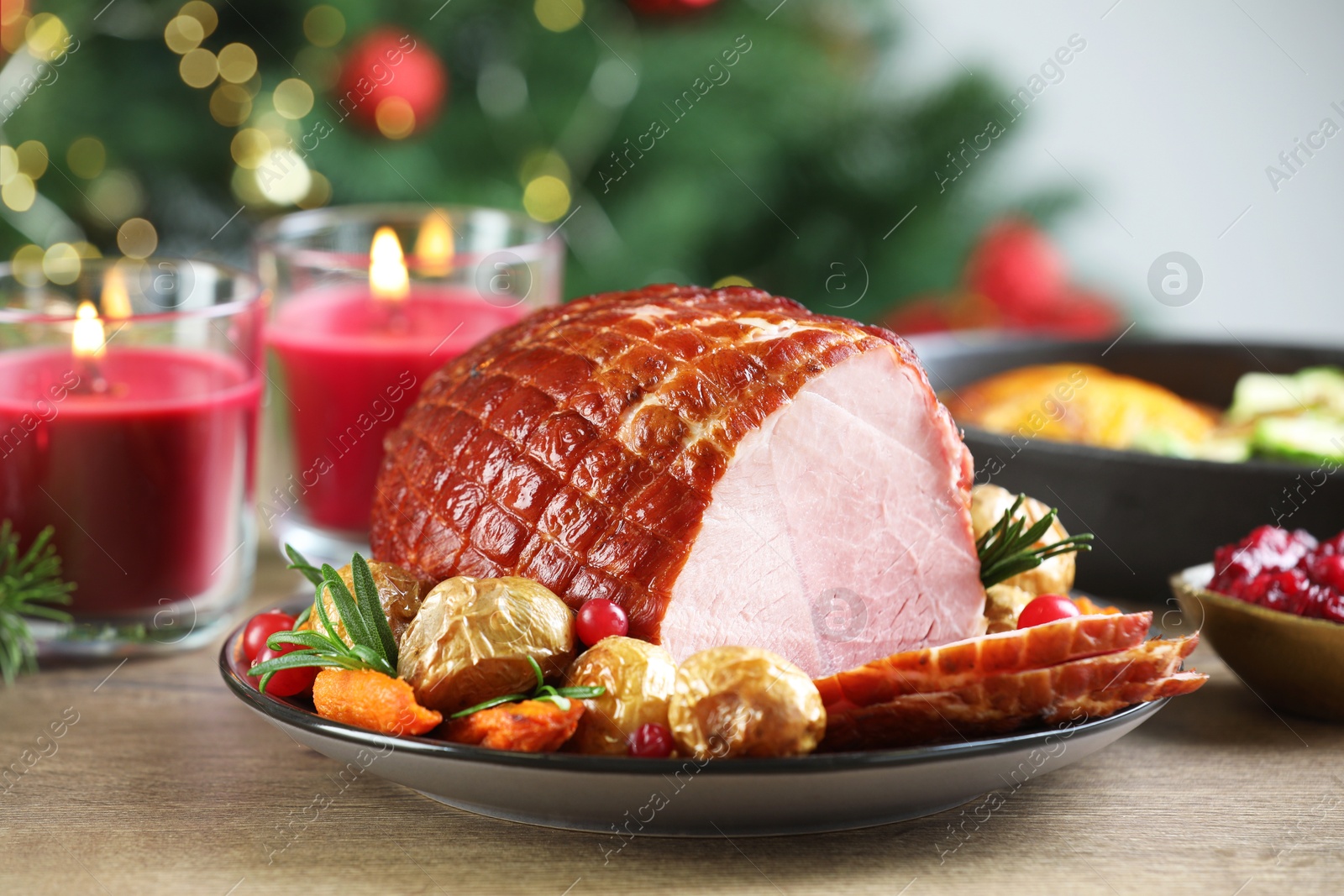 Photo of Christmas food. Tasty baked ham served on wooden table, closeup