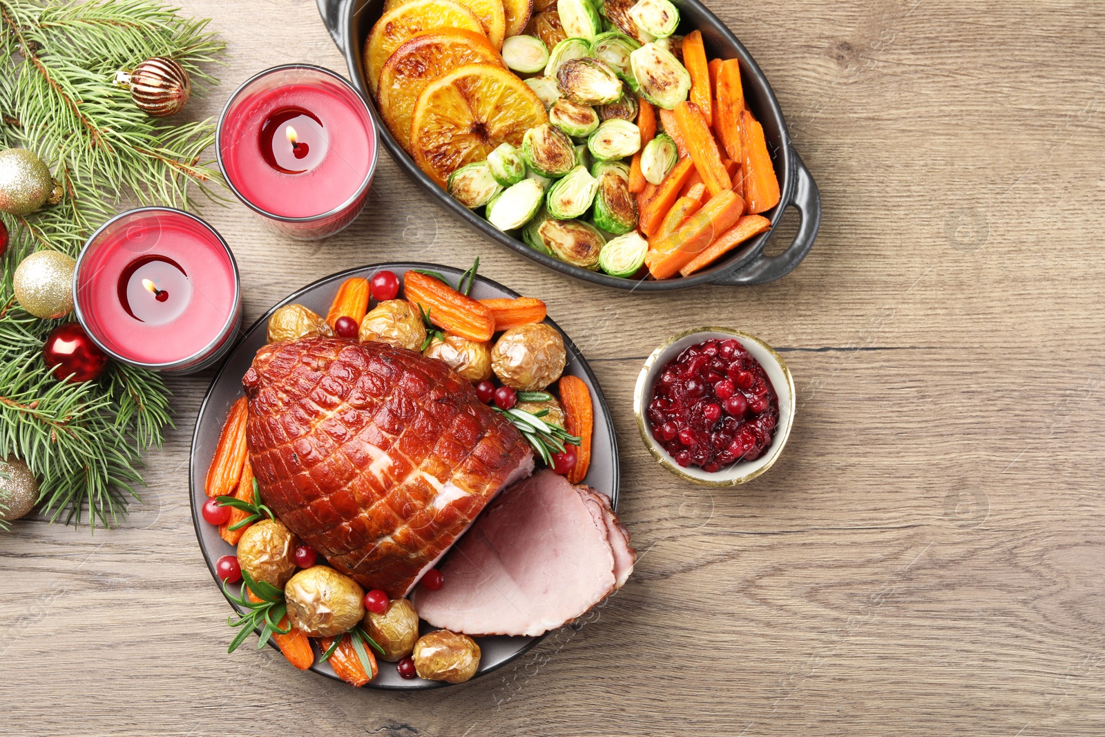 Photo of Christmas food. Tasty baked ham served on wooden table, flat lay and space for text