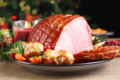 Photo of Christmas food. Tasty baked ham served on wooden table, closeup