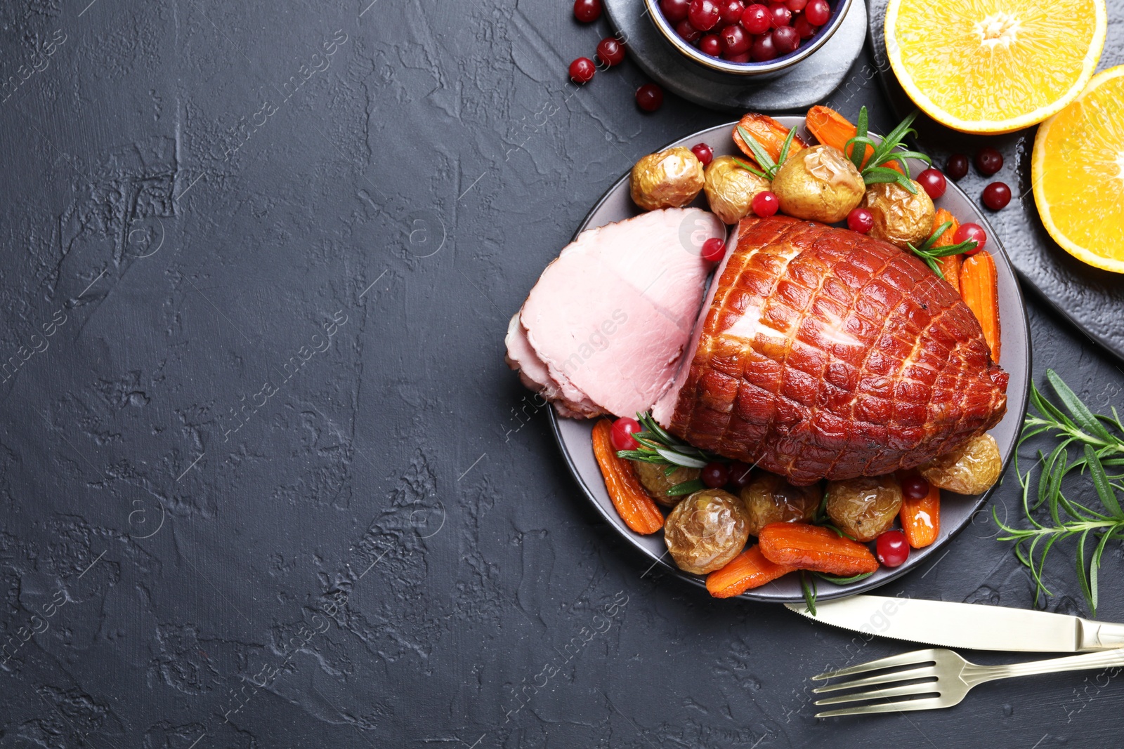 Photo of Christmas food. Tasty baked ham served on black table, flat lay and space for text