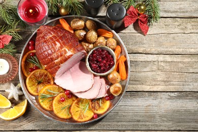 Photo of Christmas food. Tasty baked ham served on wooden table, flat lay and space for text