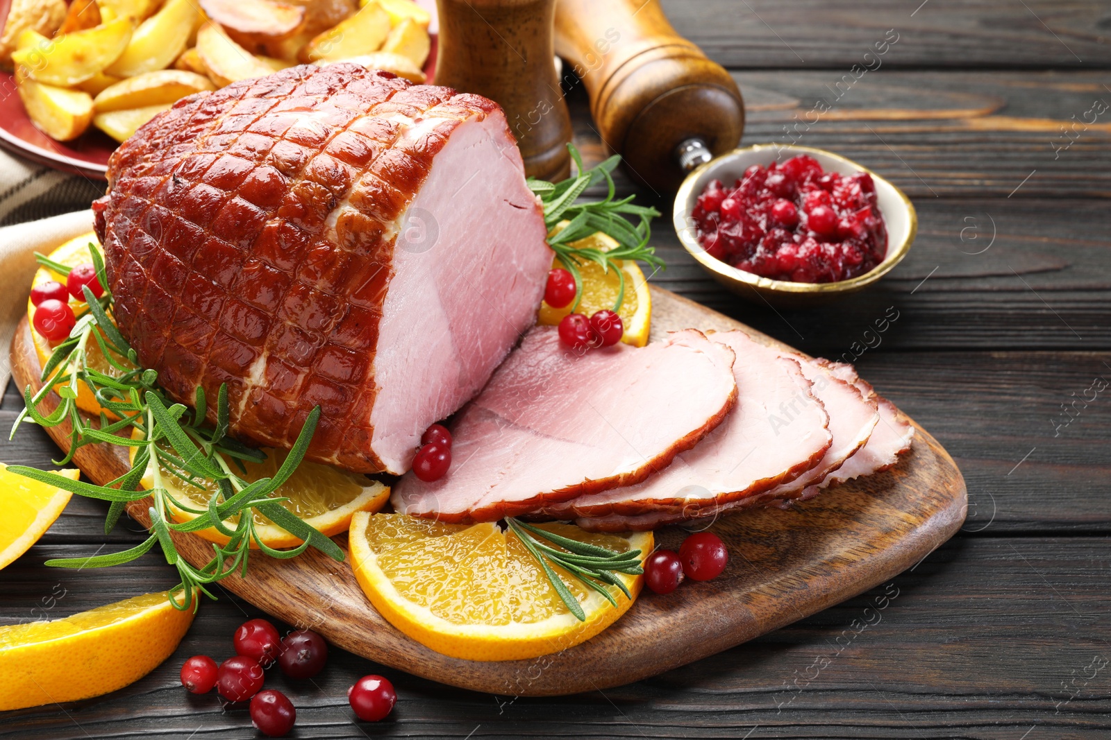 Photo of Christmas food. Tasty baked ham served on wooden table, closeup