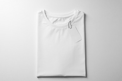 Photo of Blank t-shirt on white background, top view. Mockup for design