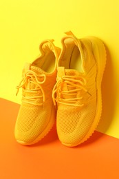 Photo of Pair of stylish sneakers on color background