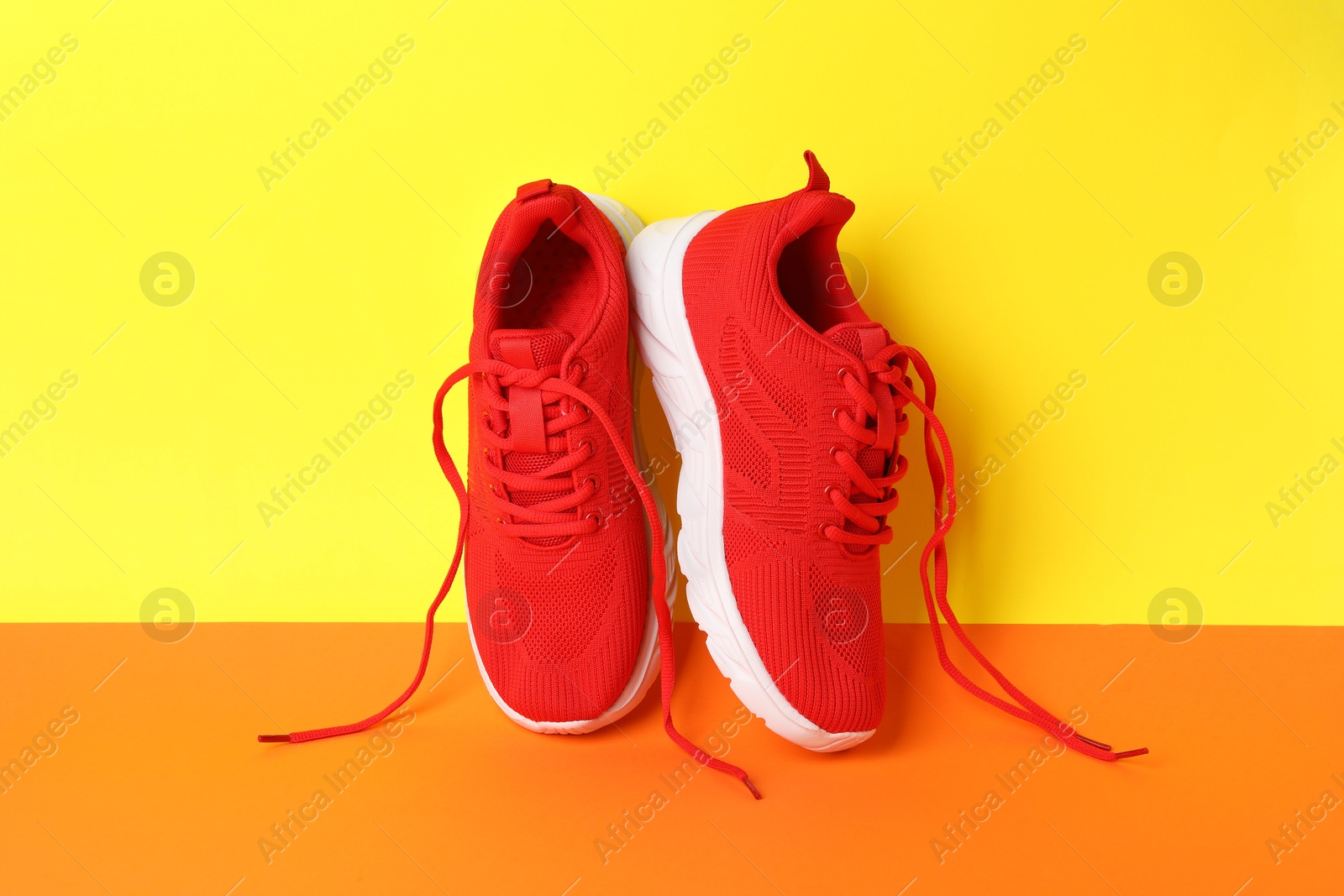 Photo of Pair of stylish sneakers on color background