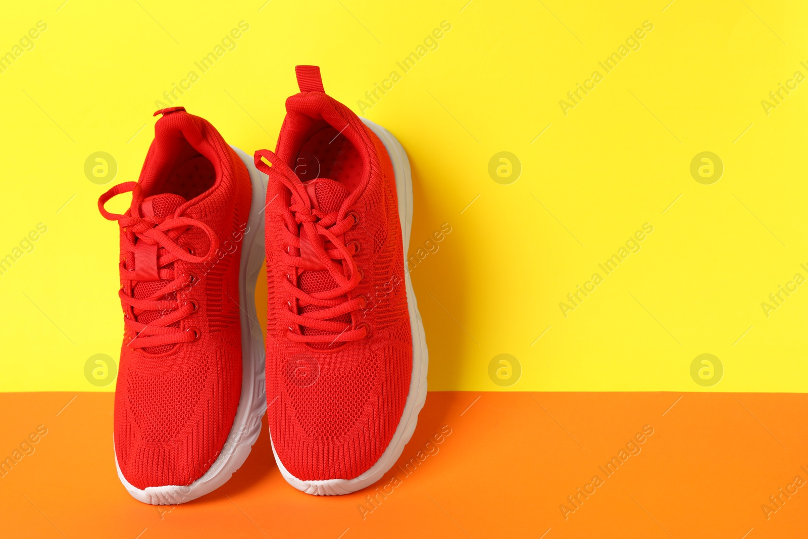 Photo of Pair of stylish sneakers on color background. Space for text