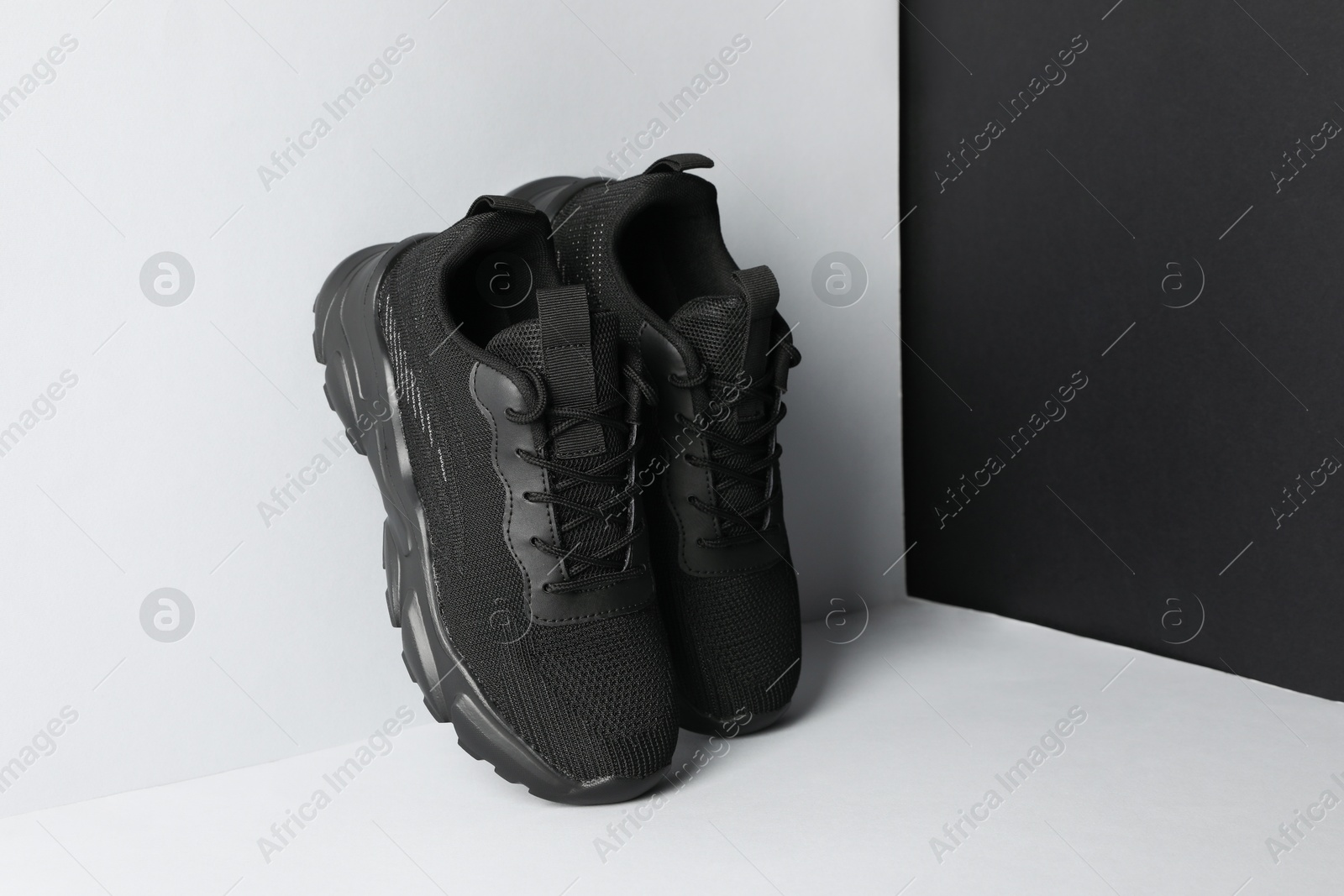 Photo of Pair of stylish sneakers on color background