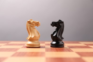 Photo of Black and white chess pawns in middle of chessboard. Competition concept