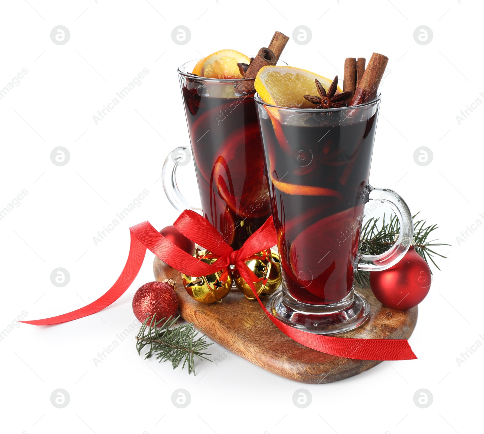 Photo of Tasty mulled wine with spices and Christmas decor isolated on white