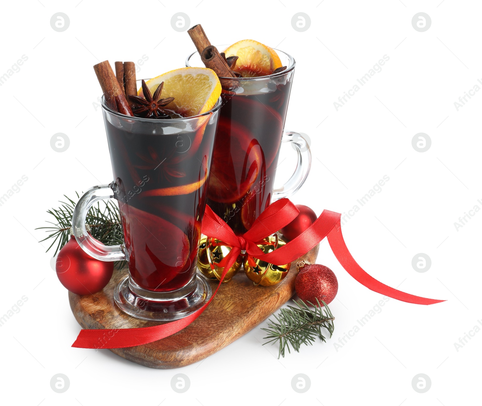 Photo of Tasty mulled wine with spices and Christmas decor isolated on white